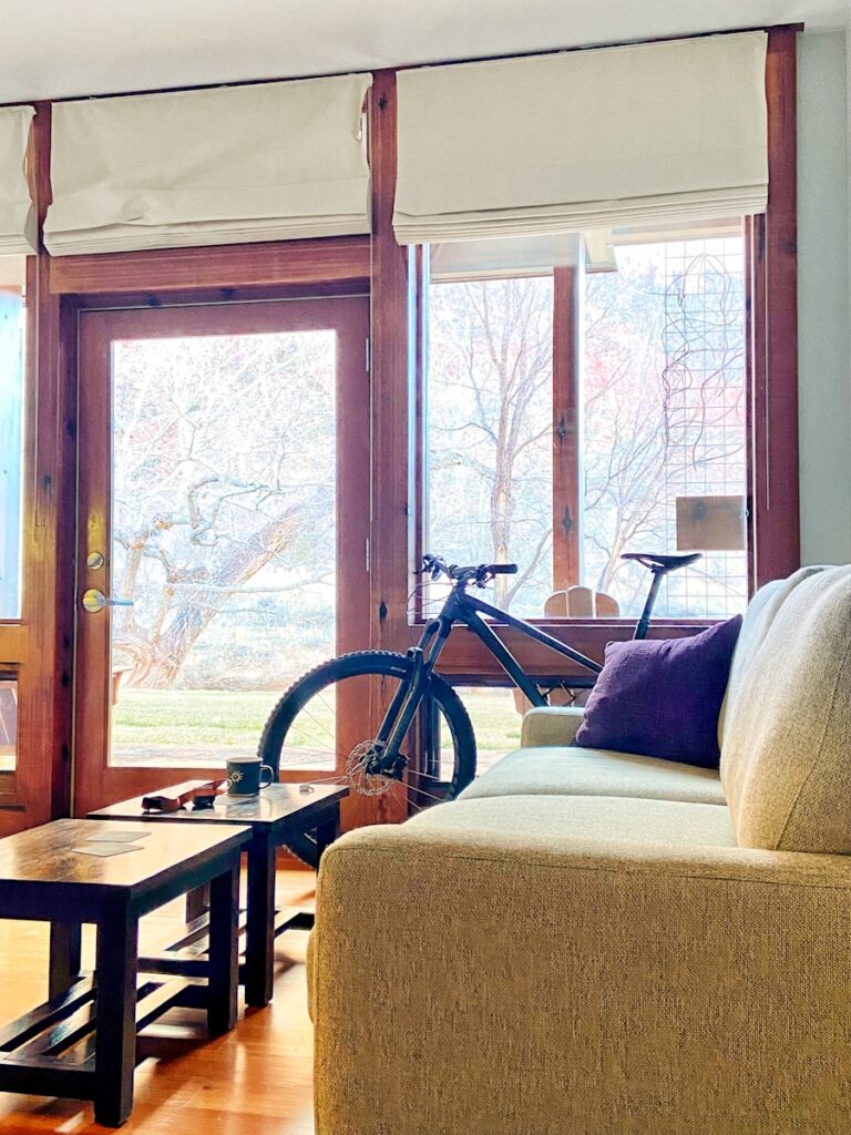 a living room filled with furniture and a bike