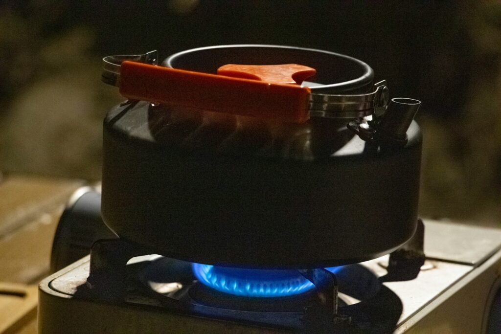 A stove with a blue flame on top of it